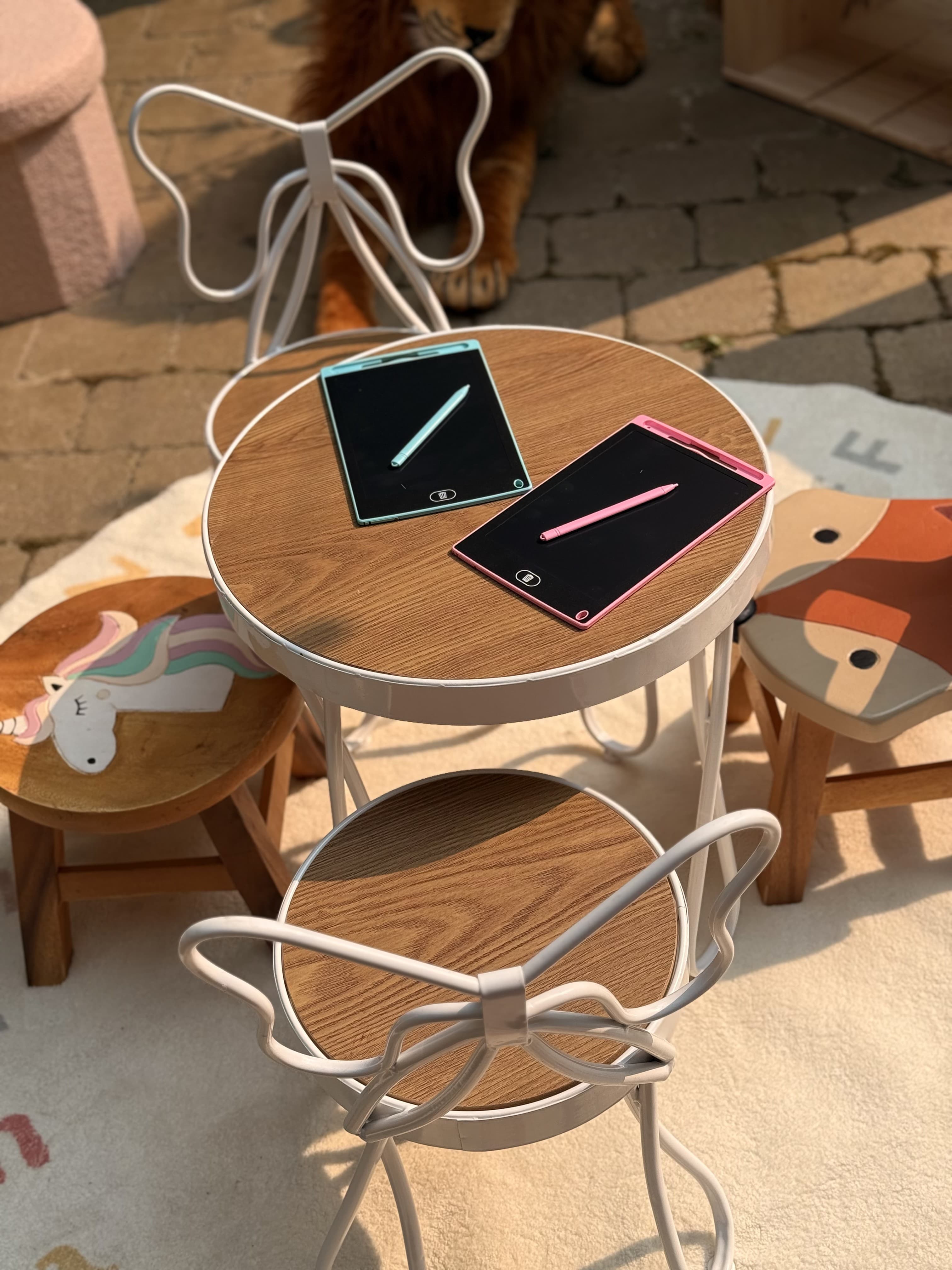 Kids activity table with tablets and butterfly-back chairs