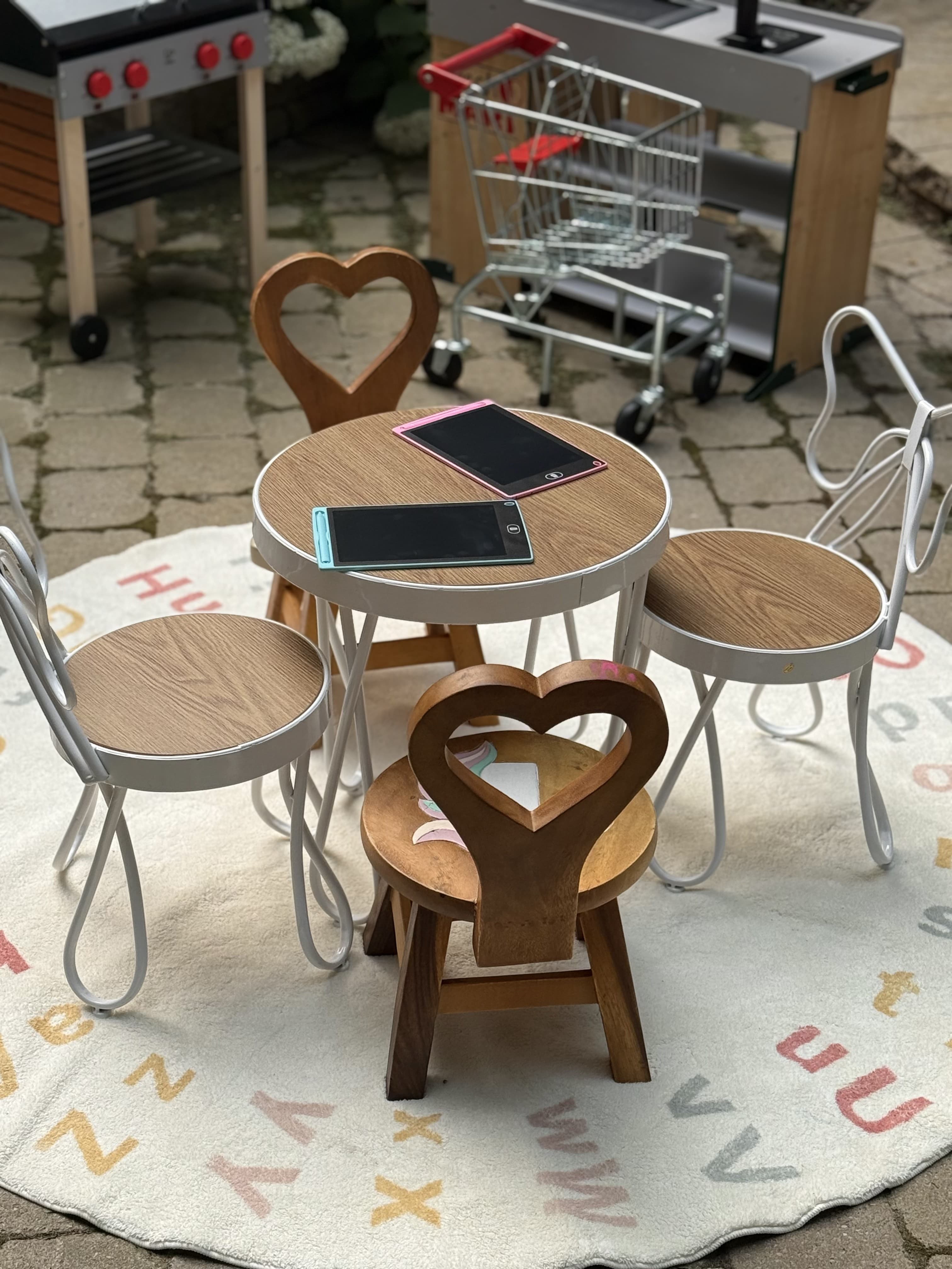 Kids table and chairs play setup with heart-shaped chair backs