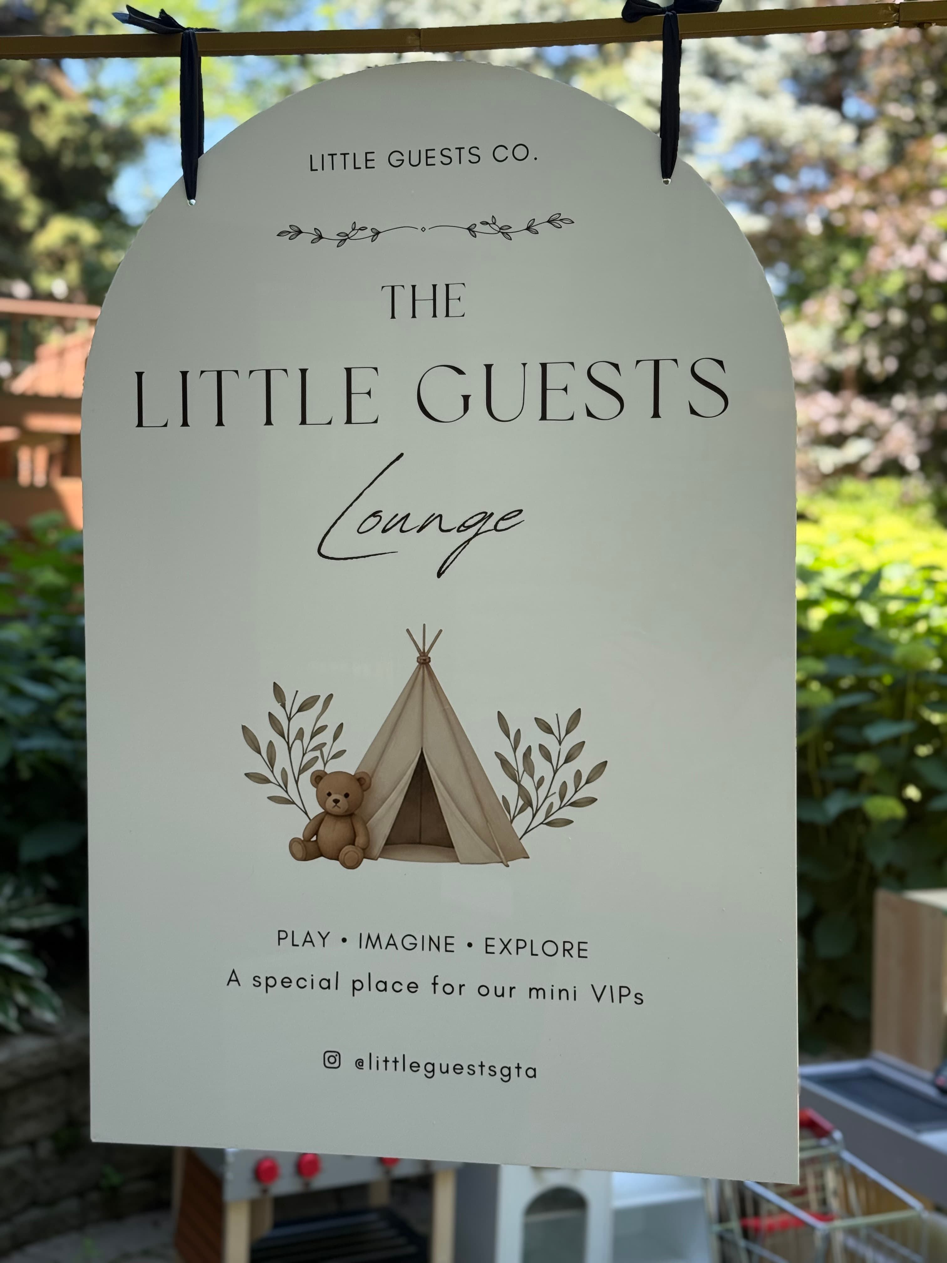 The Little Guests Co. branded signboard displayed at a client event